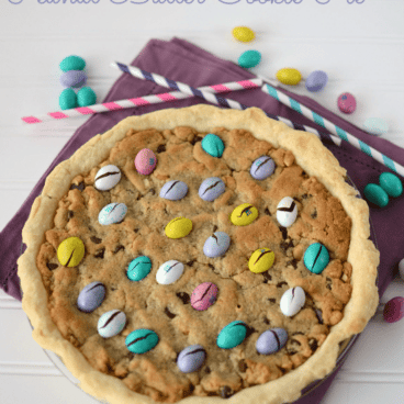 peanut butter cookie pie overhead with easter egg m and ms on purple napkin
