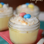 coconut cream pies in jars with jelly beans on top