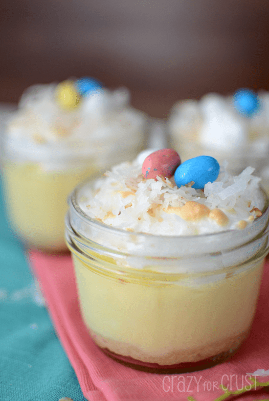 coconut cream pies in jars with jelly beans on top