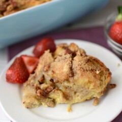 banana baked french toast on white plate with berries