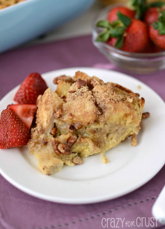 banana baked french toast on white plate with berries