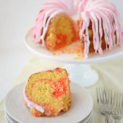 pink lemonade swirl bundt cake on stack of white plates