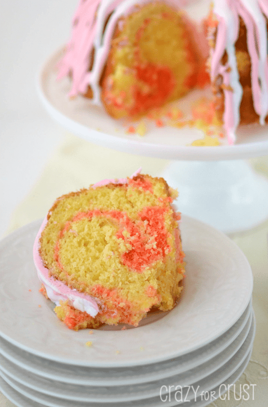 pink lemonade swirl bundt cake on stack of white plates