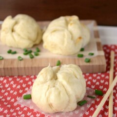 pork buns on parchment and patterned napkin with chopsticks