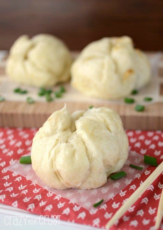 pork buns on parchment and patterned napkin with chopsticks