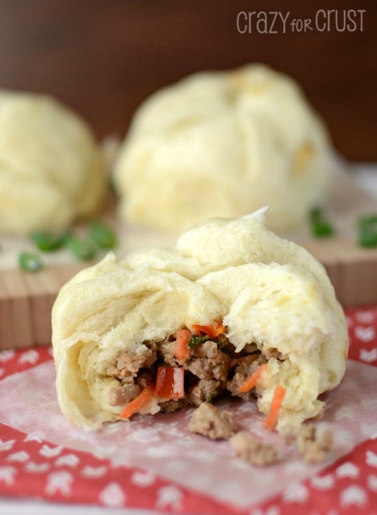 pork buns on parchment and patterned napkin with chopsticks