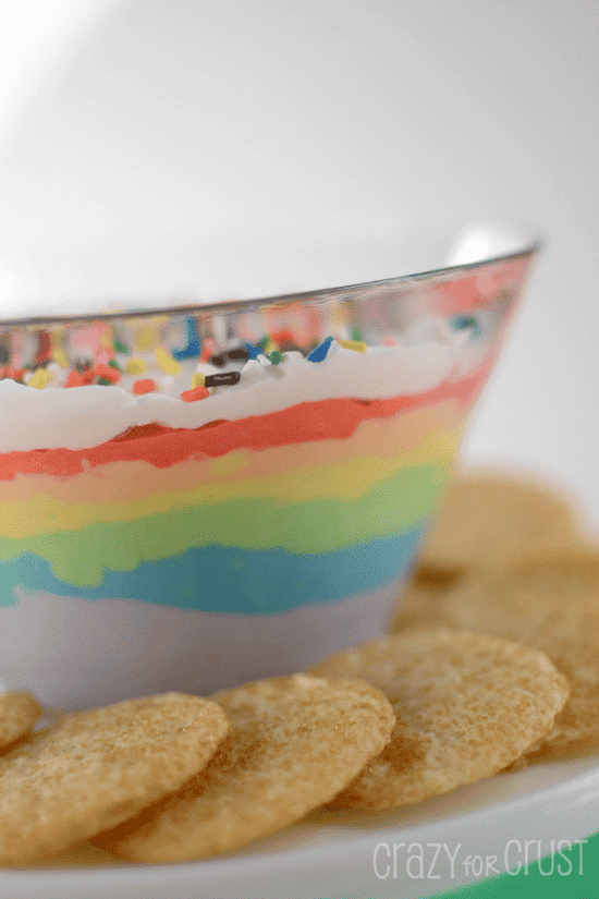 rainbow dip with cookies around on cake plate 