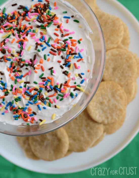 rainbow dip with cookies around on cake plate 