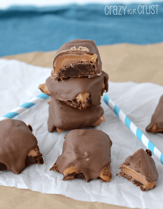 Stack of Milky Way brownie bites with top one cut in half to show the filling