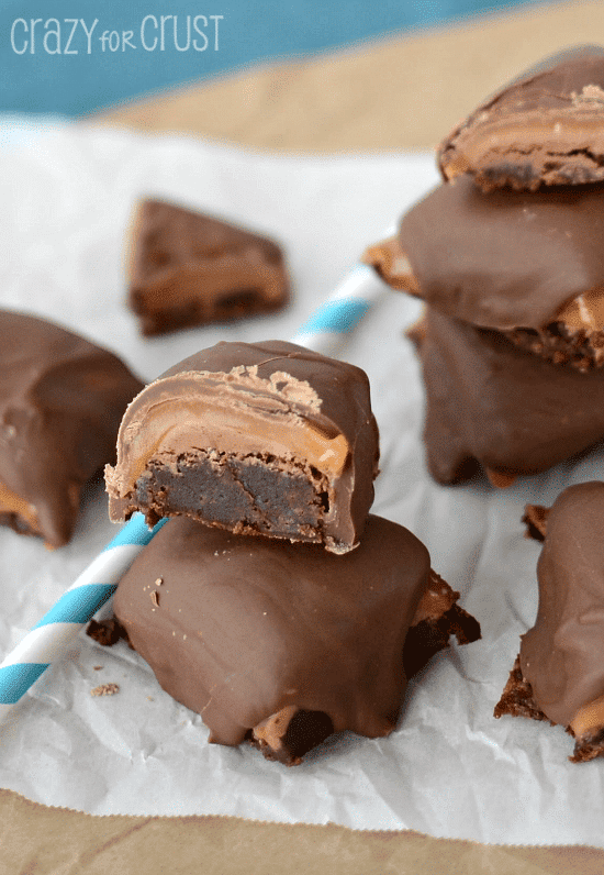 Close up shot of two Milky Way brownie bites on top of eachother with blue and white straw