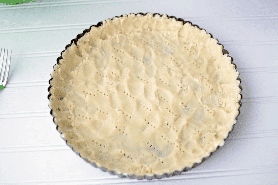 Nutella Strawberry Tart Crust in a metal pie pan on white table