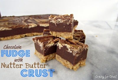 Chocolate Fudge with Nutter Butter Crust pieces stacked on kitchen marble counter with recipe title in bottom left corner