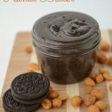 Oreo Peanut Butter in a jar with oreos and peanuts around on cutting board with words on photo