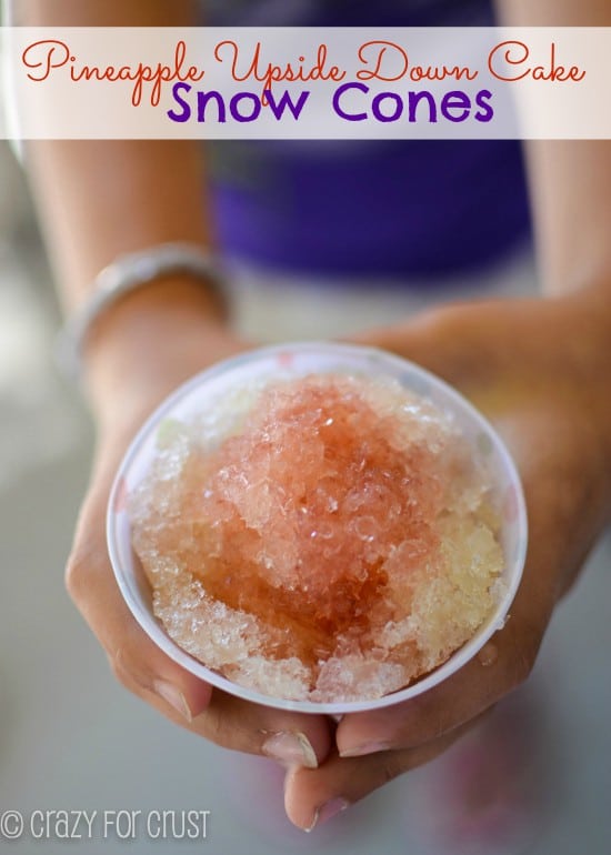 girl holding snow cone that is pineapple upside down cake flavor