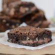 slice of chocolate cake bar with walnuts on parchment paper