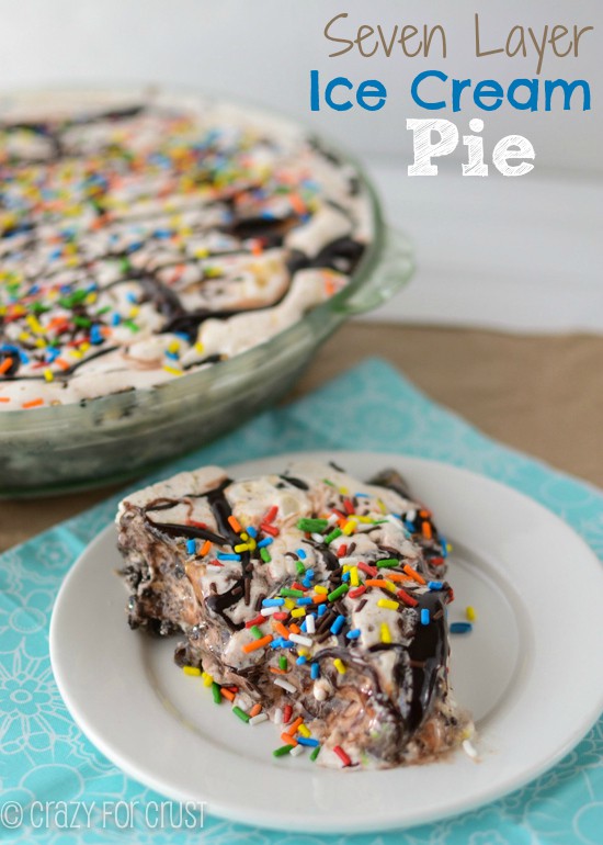 slice of ice cream pie on white plate with hot fudge and sprinkles