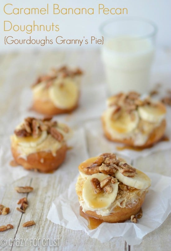 fried doughnut on parchment paper topped with bananas nuts and caramel