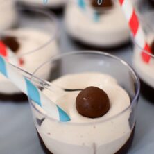 malted pudding in small dish with malt ball on top and striped straw