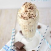 ice cream in tall sundae cup with chocolate on top and words on photo