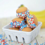 ice cream sandwiches made with small cookies and sprinkles in a stack in a basket