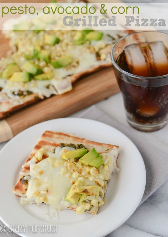 slice of grilled pizza with corn and avocado on plate