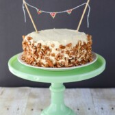 carrot cake ice cream cake with nuts outside on green cake stand
