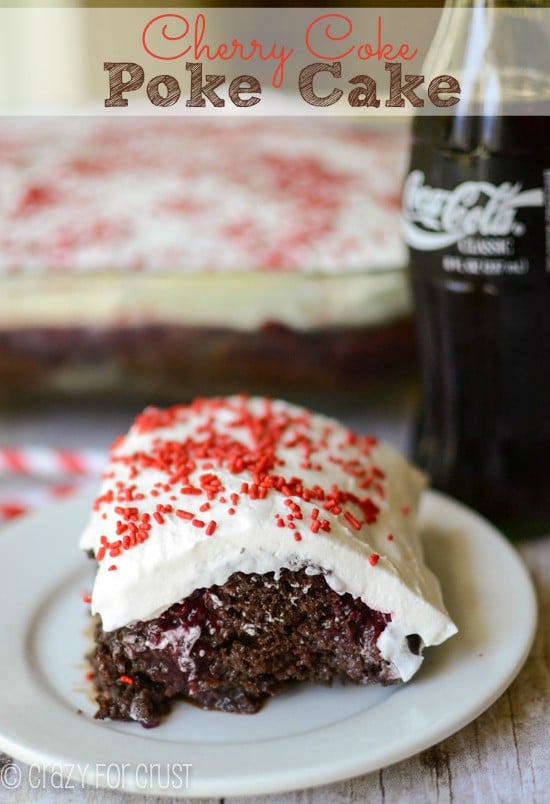 cherry coke poke cake sitting on white plate with Coca Cola bottle in the background