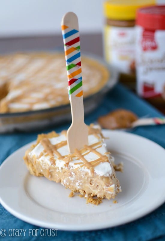 slice of frozen pie on white plate with fork standing up in it