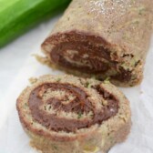 sliced zucchini cake roll with chocolate filling on white platter