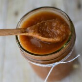 crockpot applesauce in jar with spoon