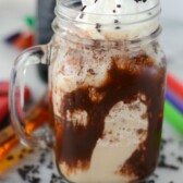 rootbeer float in jar mug with chocolate sauce and whipped cream