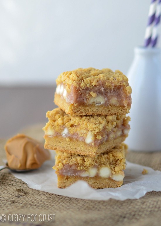 Stack of PB&J Gooey Bars on Parchment paper