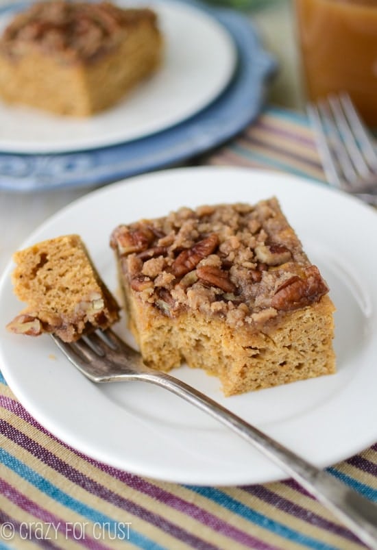 slice of pumpkin coffee cake on white plate with bite missing