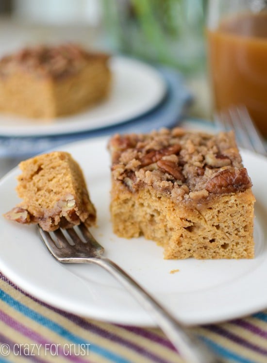 slice of pumpkin coffee cake on white plate with bite taken off and on silver fork