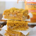 stack of pumpkin gooey bars with toffee bits on brown table