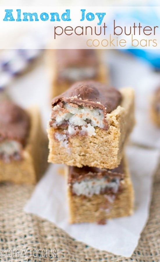 Two Almond Joy Peanut Butter Cookie Bars stacked on top of eachother with recipe title on top of photo