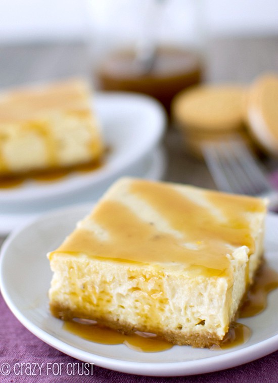 slice of banana cheesecake bar on white plate with caramel sauce