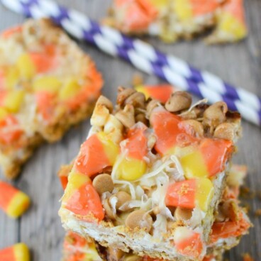 overhead shot of stack of candy corn magic bars with candy corn candy around