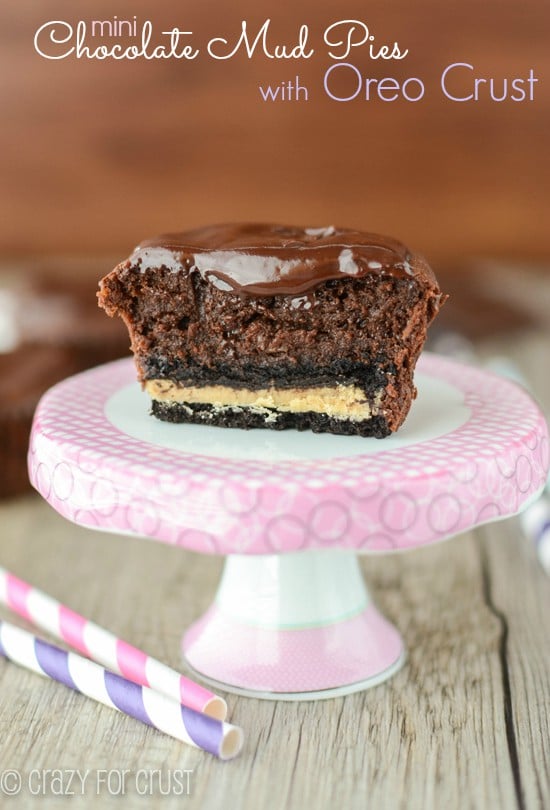 Mini Chocolate Mud Pies with Oreo Crust cut in half on a pink cake stand with title
