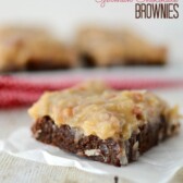 german chocolate brownie with coconut pecan frosting on parchment paper