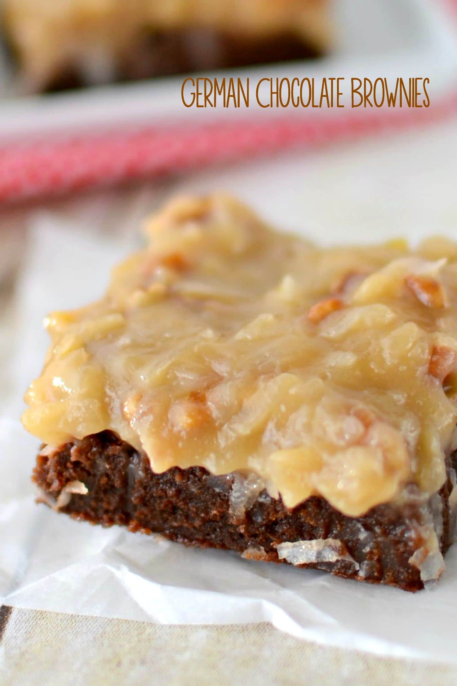 german chocolate brownie with coconut pecan frosting on parchment paper