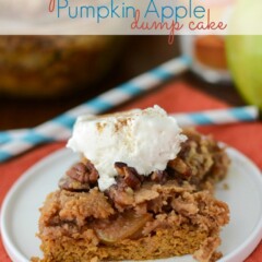 pumpkin apple dump cake slice on white plate with whipped cream