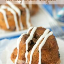 blueberry monkey bread muffin on white plate with drizzle