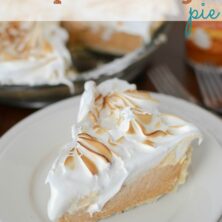 pumpkin pie slice topped with meringue on white plate