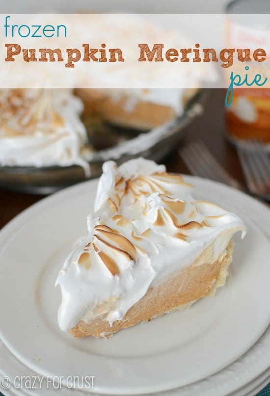 pumpkin pie slice topped with meringue on white plate