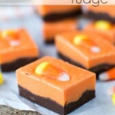 pieces of halloween fudge with chocolate bottom and orange top and candy corn on parchment and burlap