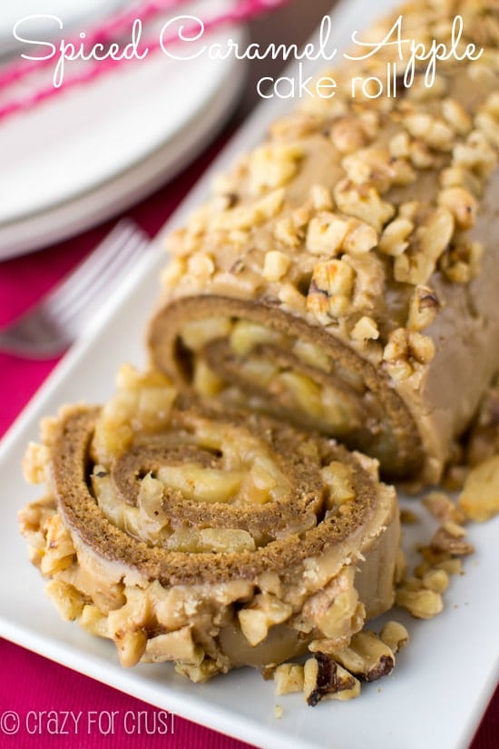 Spiced caramel apple cake roll on a white plate with title.