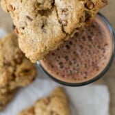 cinnamon scone with cinnamon chips on top of glass of chocolate milk