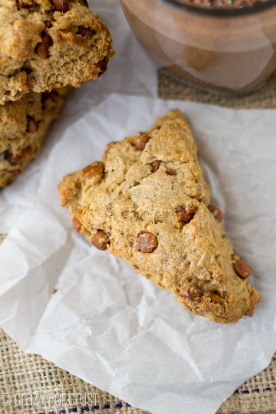 Closeup of one Spiced Cinnamon Chip Scone on white parchment paper