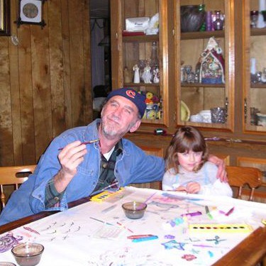 Maka and Jordan painting at a table